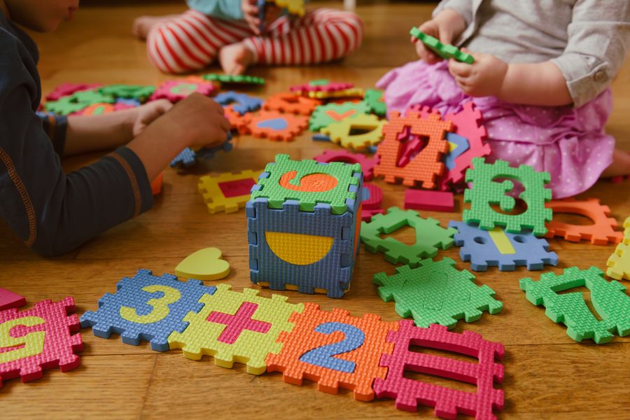 Children assembling a number puzzle mat